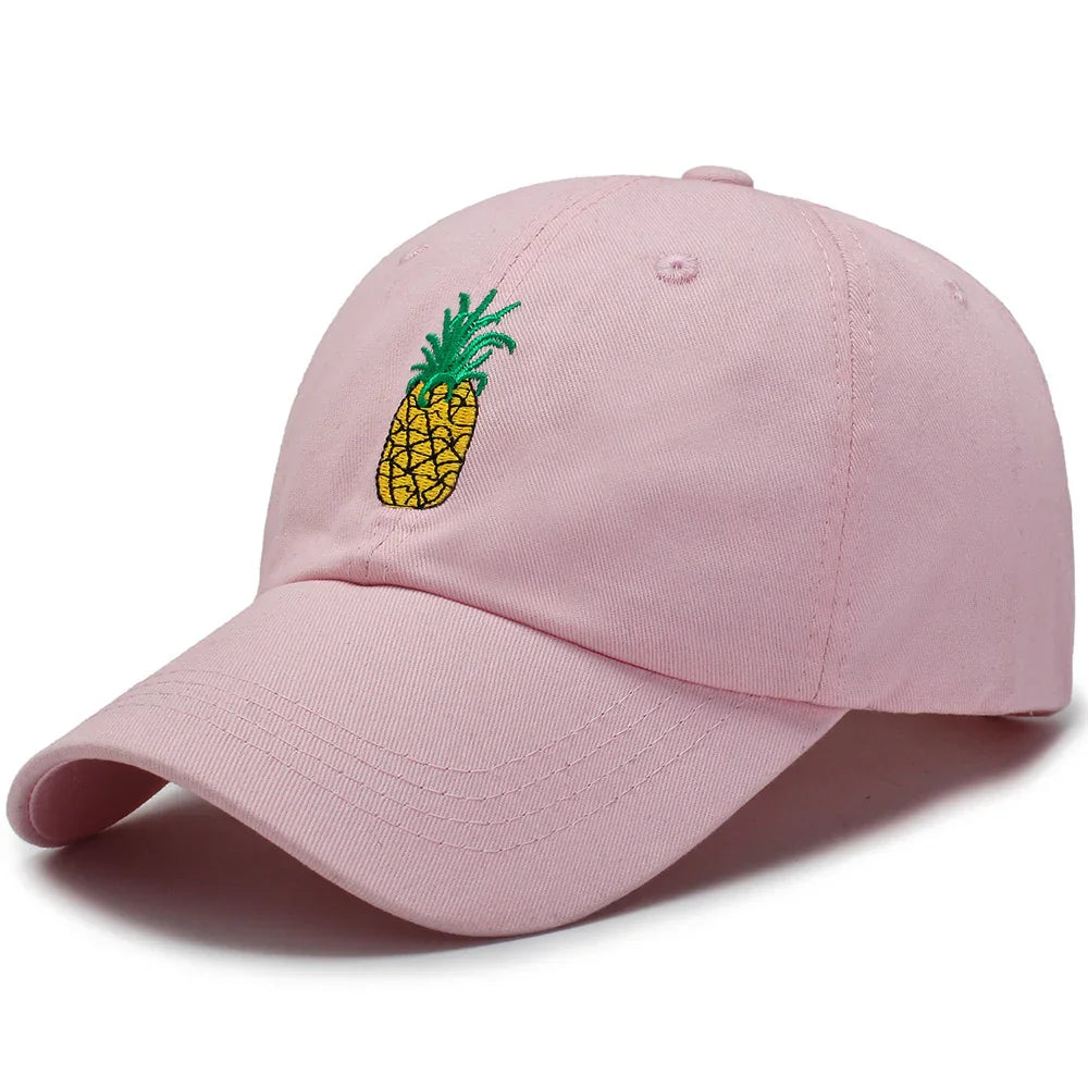 Pink baseball cap with embroidered yellow pineapple and green leaves on front