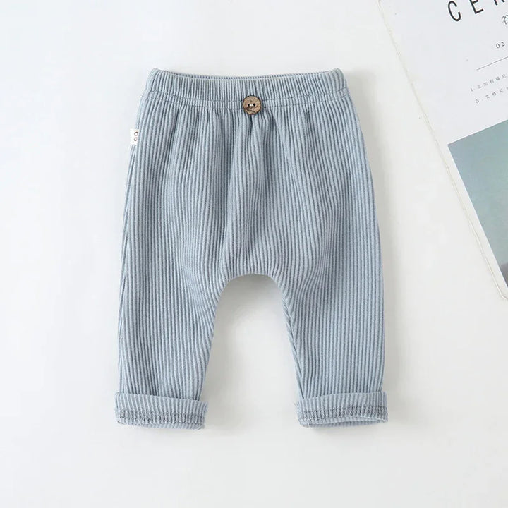 Baby ribbed blue cotton pants with elastic waist and wooden button detail
