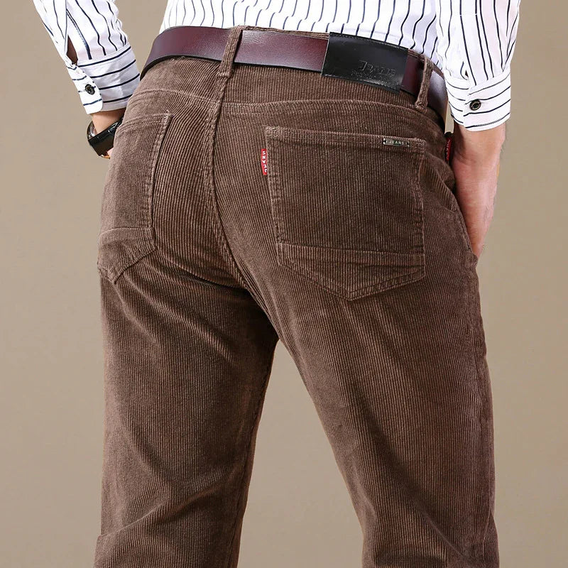 Close-up of man wearing brown corduroy pants with a leather belt and striped shirt