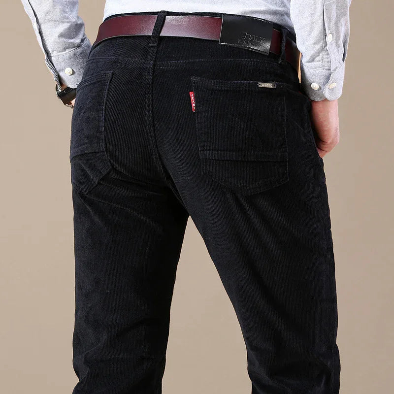 Man wearing black corduroy jeans with back pockets and a brown leather belt