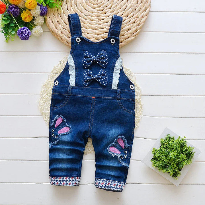 Denim baby overalls with lace details, polka dot bows, and butterfly patches on knees