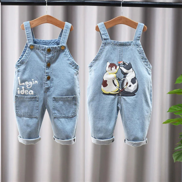 Light blue toddler denim overalls with front pockets, button details, and cat graphic on back