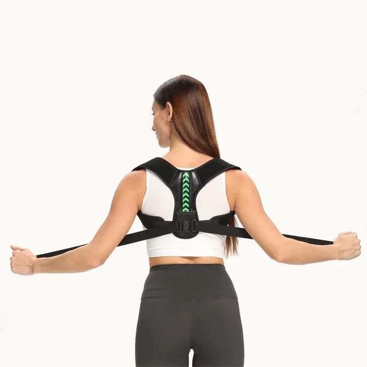 Woman wearing black posture corrector back brace and sportswear, adjusting straps.