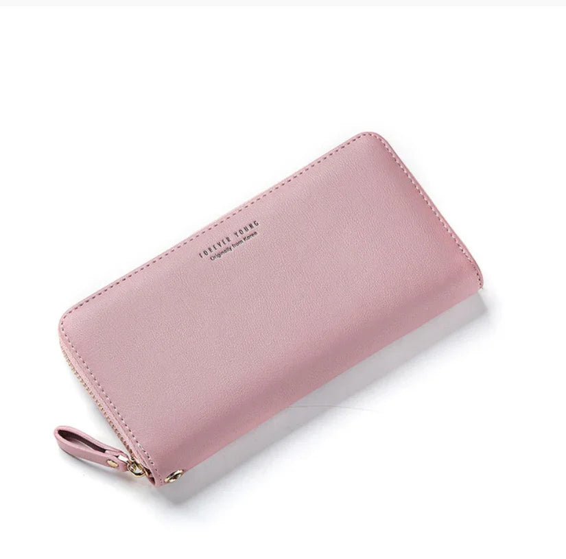 Pink leather zip-around wallet with wrist strap and embossed FOREVER YOUNG text