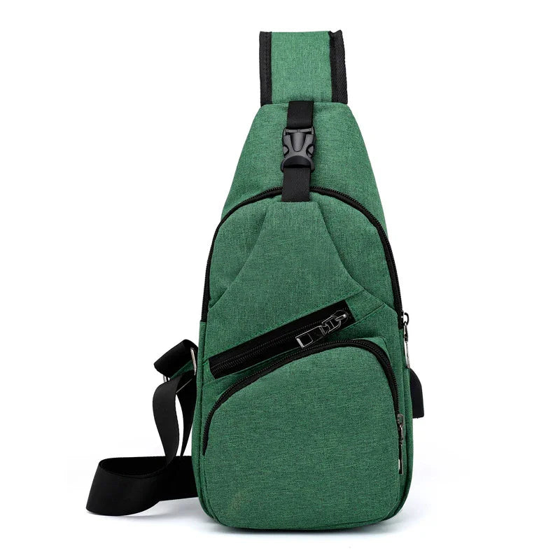 Green sling backpack with black zipper pockets and adjustable strap on white background