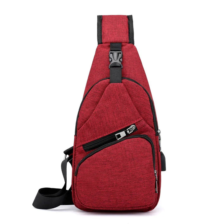 Red crossbody sling bag with multiple zippered compartments and black adjustable strap