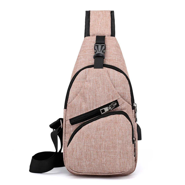 Compact pink crossbody sling bag with black zippers and adjustable strap on white background