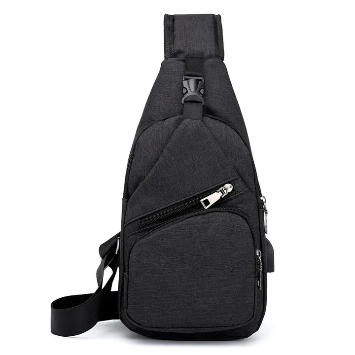 Black crossbody sling bag with multiple zippered compartments and adjustable strap