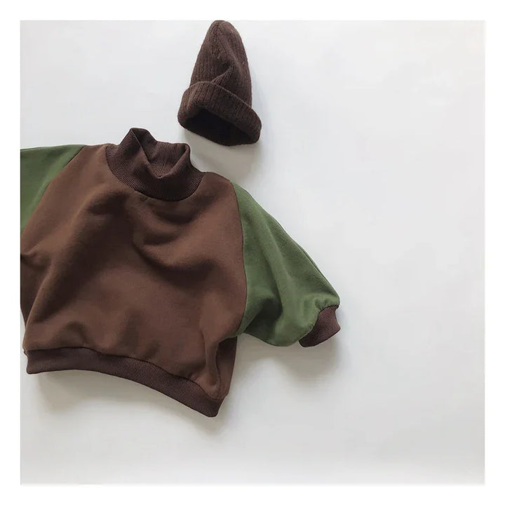 Brown and green long sleeve sweatshirt with a brown knit beanie hat on white background