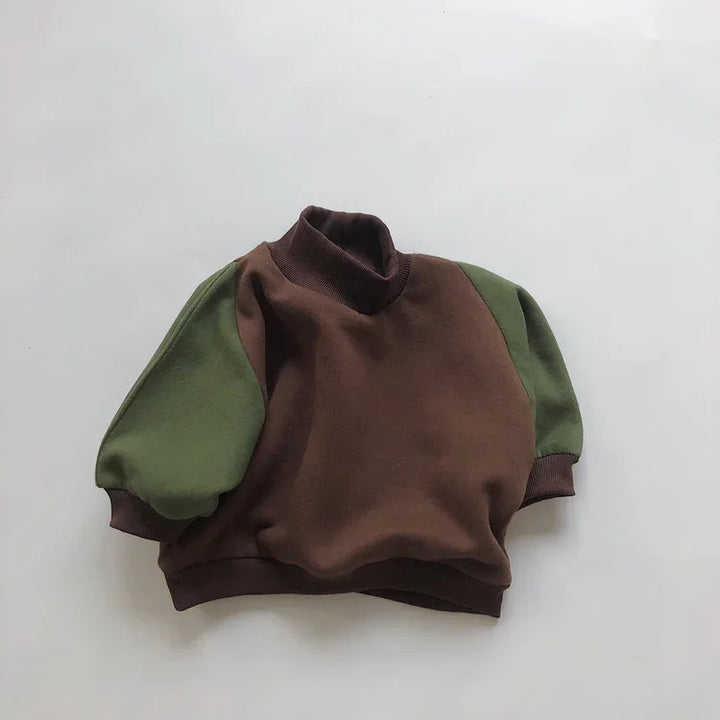 Brown and olive green toddler pullover with high collar and puff sleeves on white background