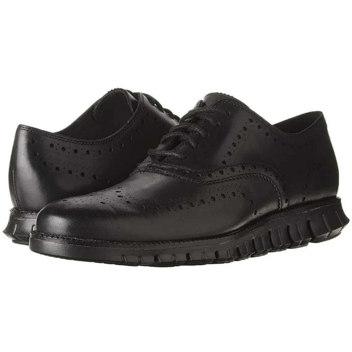 Black leather men's wingtip brogue shoes with perforated detailing and flexible soles