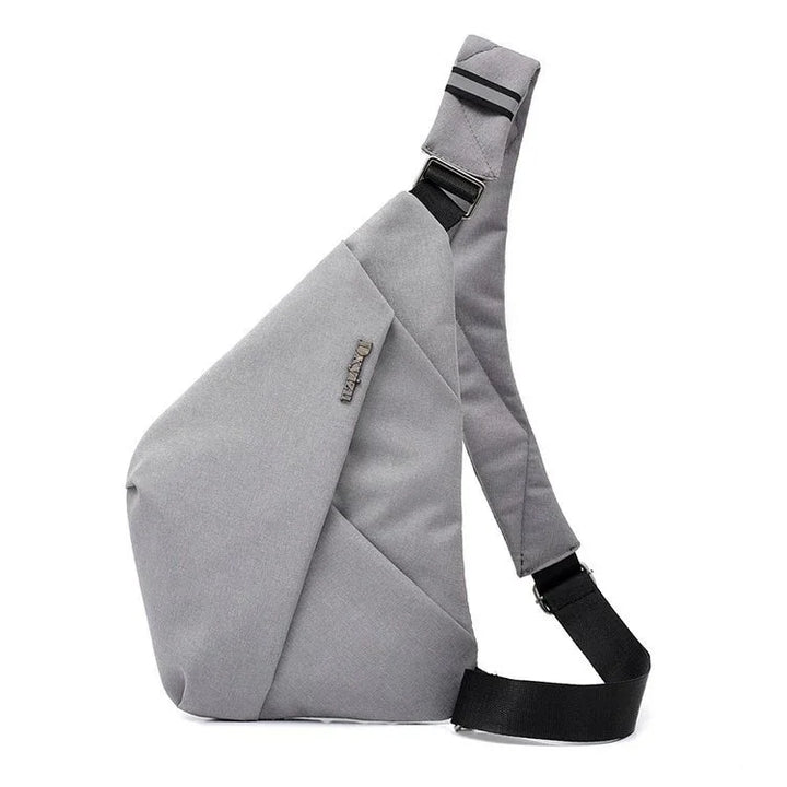 Modern grey sling backpack with adjustable black strap on white background