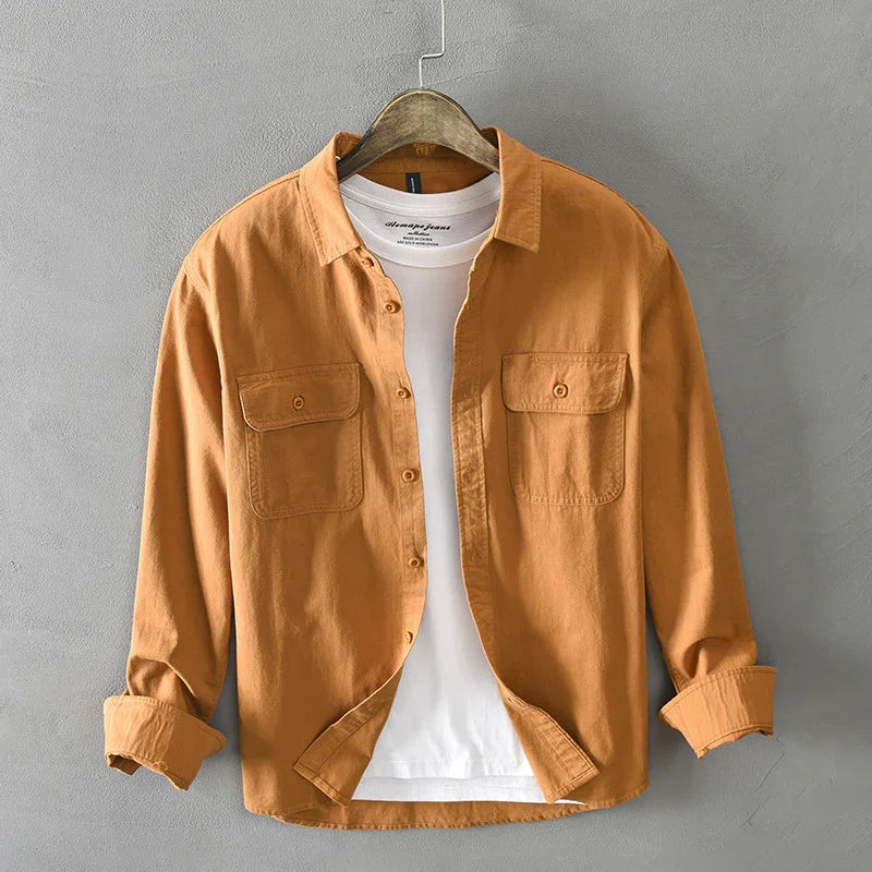 Men's casual orange button-up shirt with chest pockets over white t-shirt on wooden hanger