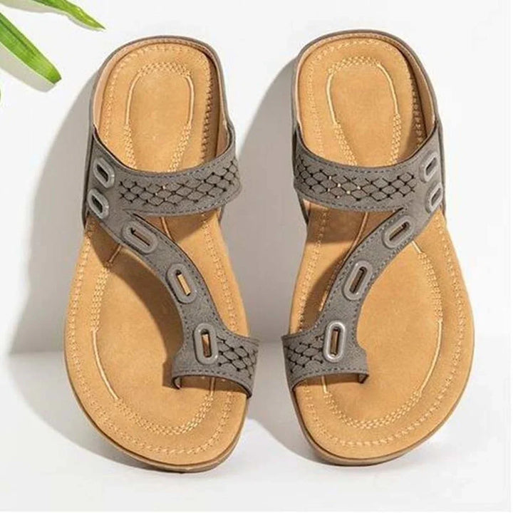 Brown leather sandals with gray woven straps on white background