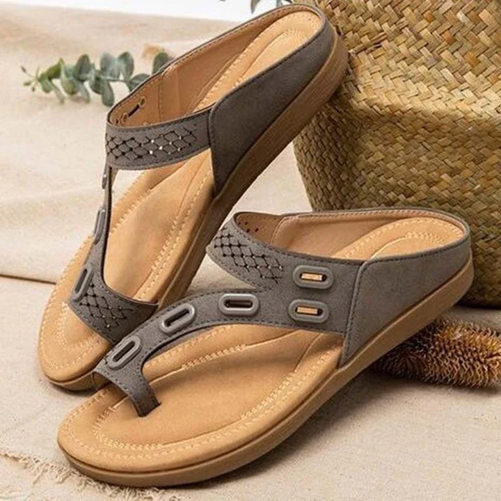 Comfortable grey and tan women's flip flop sandals with cushioned sole and woven design