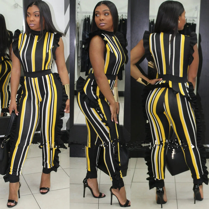 Woman wearing black, yellow, and white striped jumpsuit with ruffle details, posing in front of mirrors