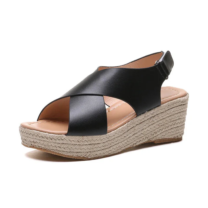 Black leather wedge sandal with crisscross straps and jute rope platform heel
