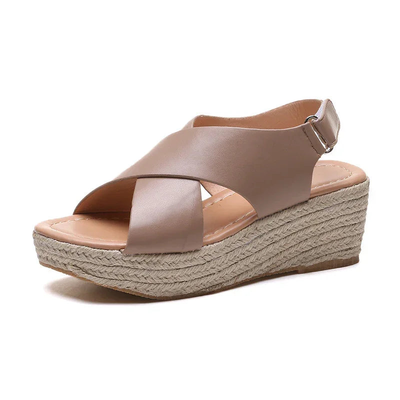 Beige leather wedge sandal with crisscross straps and braided jute platform sole