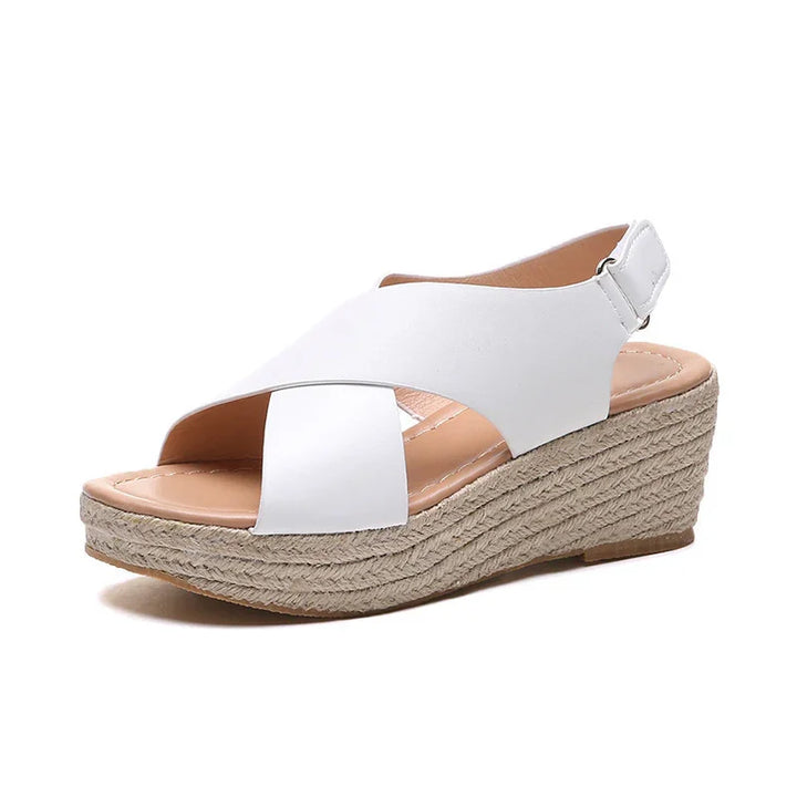 White wedge sandals with crisscross straps and woven jute platform for women
