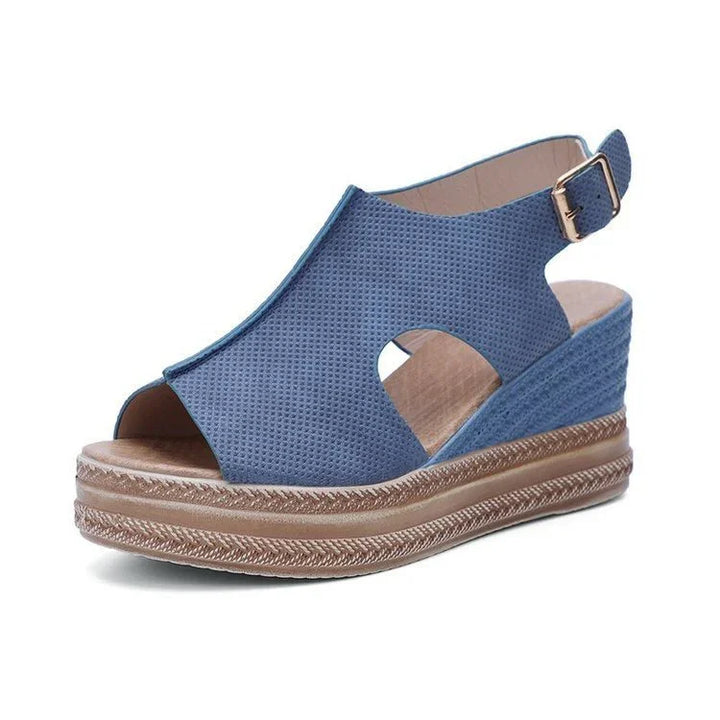 Blue women's wedge sandal with perforated upper, open toe, ankle strap, and braided platform sole