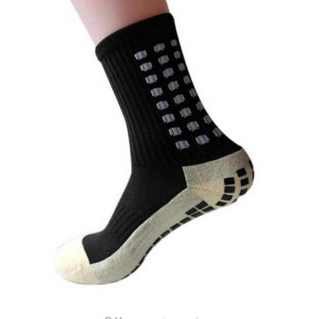Black non-slip grip sock with white cushioned sole and square traction patterns