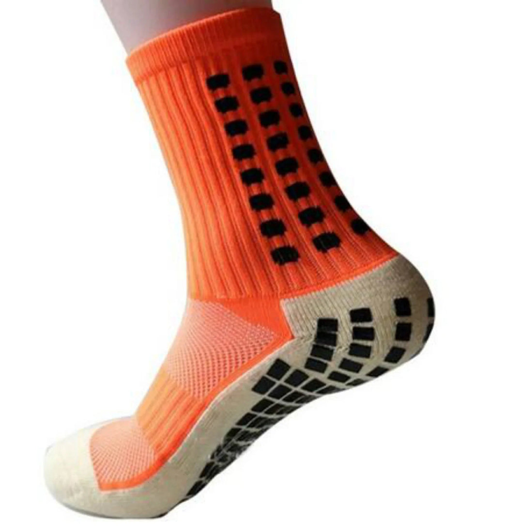 Orange non-slip athletic sock with black grip pads on the sole and side