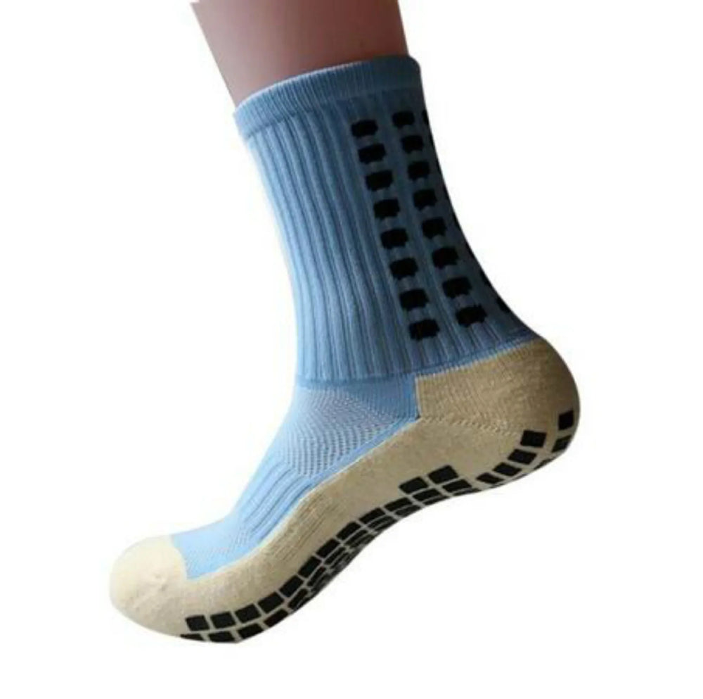 Light blue non-slip grip sock with black rubber dots on sole and sides, isolated on white