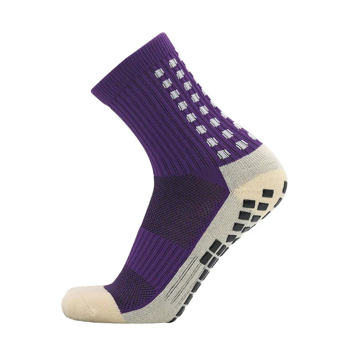Purple grip athletic sock with white dots and non-slip black sole on white background