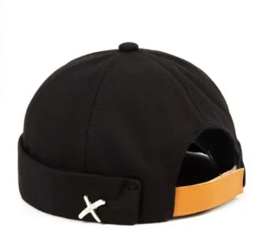 Black beanie cap with a folded cuff featuring a white stitched X and an orange adjustable strap