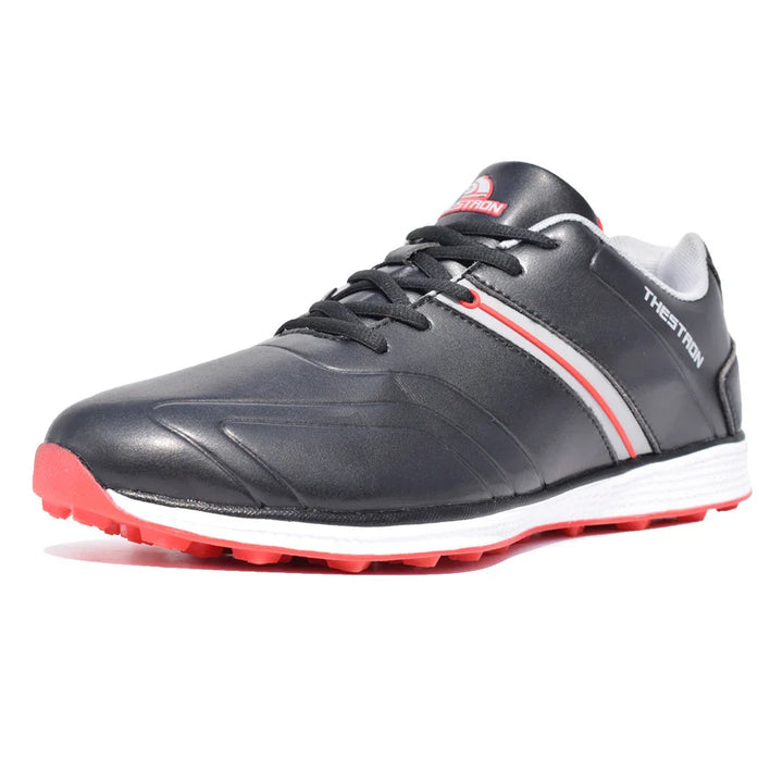 Black athletic sneaker with red and white accents, red sole, and THESATRON logo on side