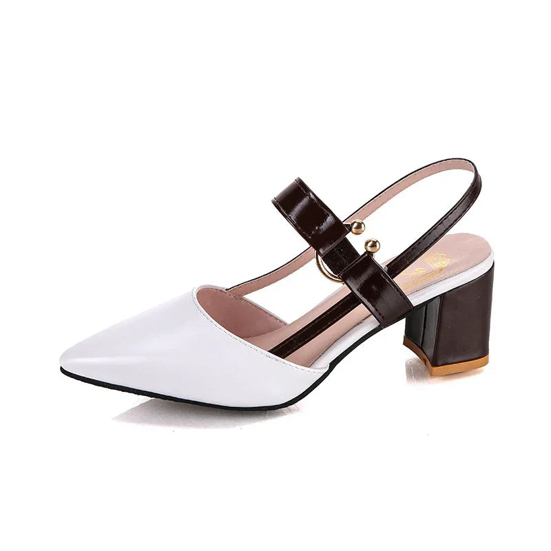 White pointed toe slingback shoe with black block heel and decorative black strap with gold studs