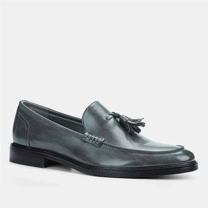 gray leather mens tassel loafers with black sole on white background