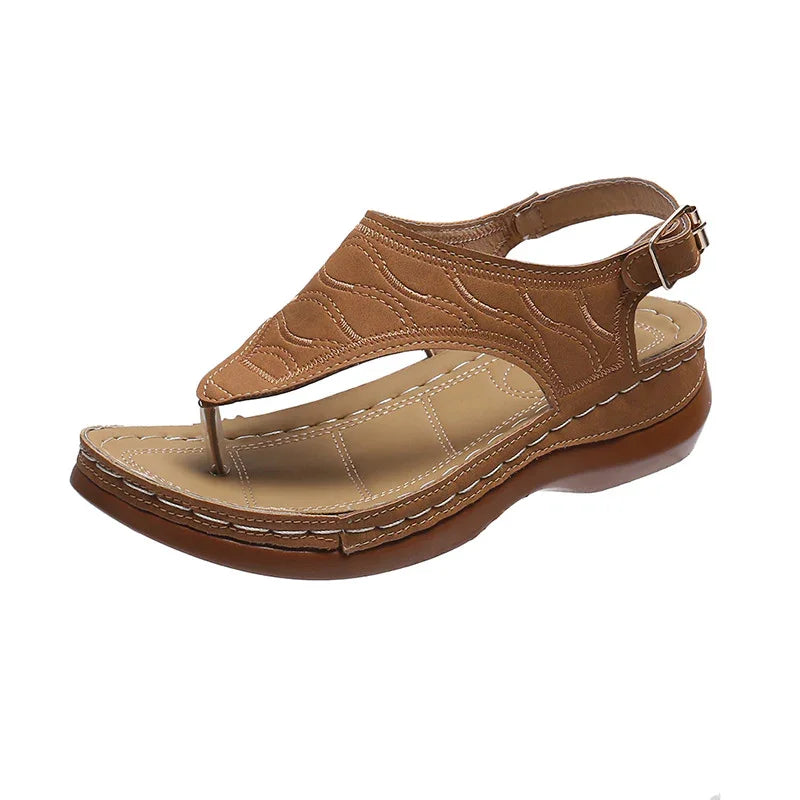 Brown women's leather thong sandal with cushioned sole and adjustable ankle strap