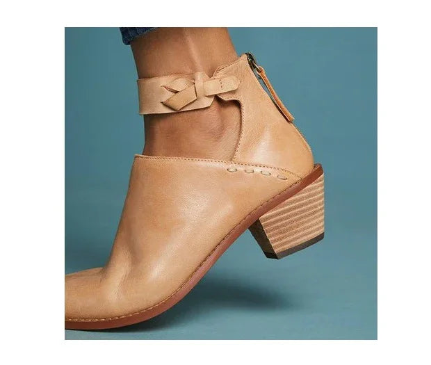 tan leather ankle boot with stacked wooden heel and bow detail on strap