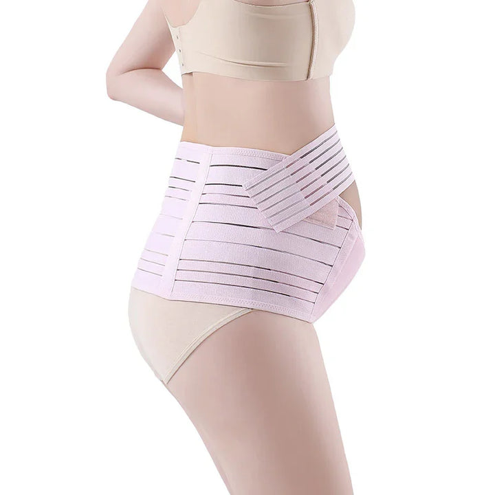 Woman wearing a beige bra and underwear with a light pink adjustable maternity support belt
