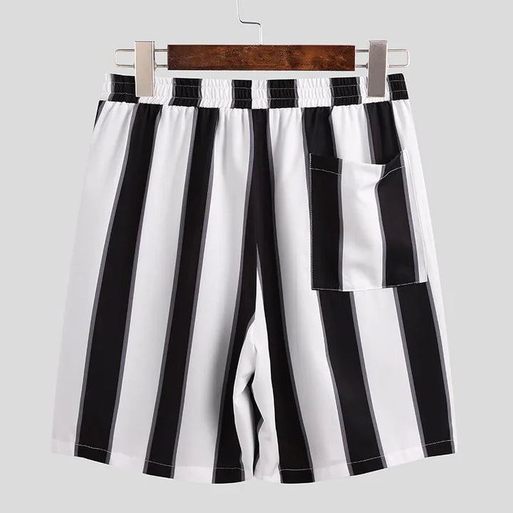 Black and white vertical striped casual shorts with elastic waistband and back pocket on hanger