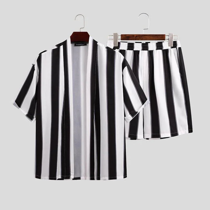 Black and white vertical striped short-sleeve shirt and matching shorts set on hangers