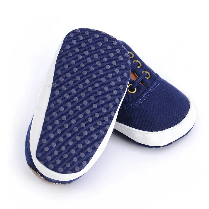 Navy blue baby shoes with white soles and non-slip dot pattern on bottom