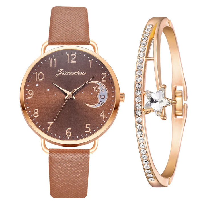 brown leather wristwatch with gold case and star moon dial next to gold bracelet with star and crystals