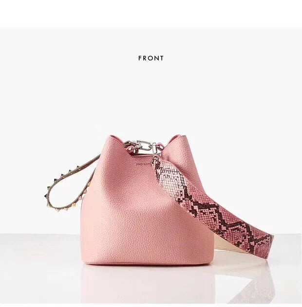 Front view of a pink leather bucket bag with a textured surface and a snakeskin-patterned strap