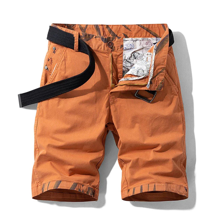 Men's orange casual shorts with black belt and patterned inner lining, front zipper open