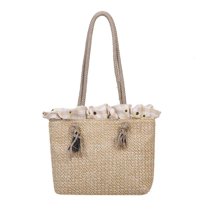 Woven straw tote bag with braided handles and fabric top featuring sunflower print