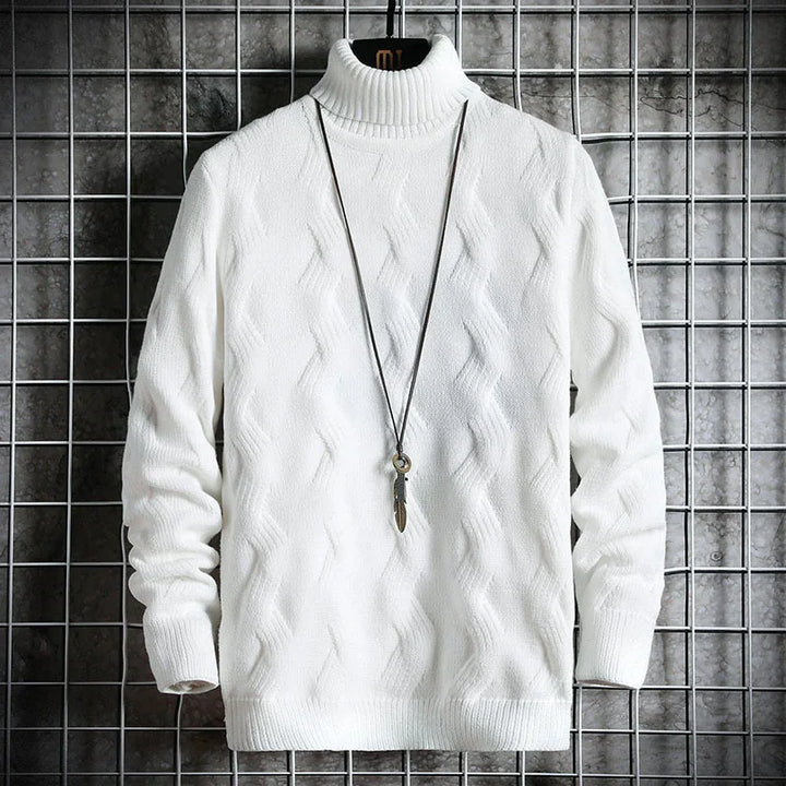 White cable knit turtleneck sweater on hanger with black necklace against metal grid background
