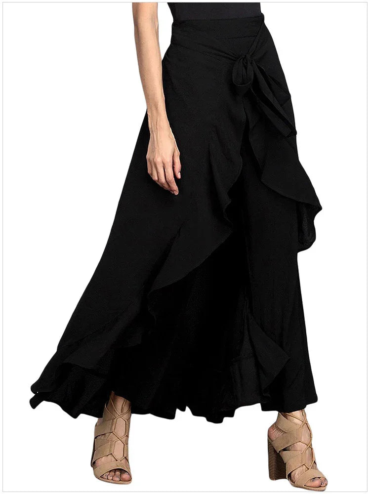 Woman wearing black asymmetrical ruffle wrap skirt with beige high heel sandals