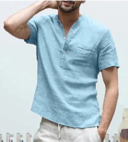 man wearing light blue short-sleeve linen shirt with buttoned collar and chest pocket