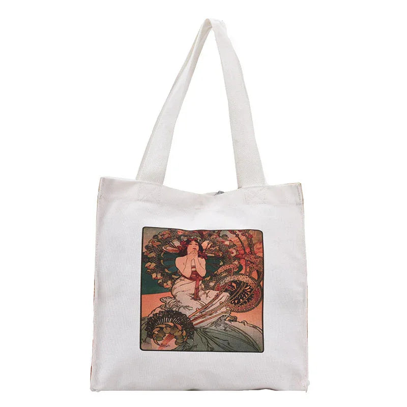 White canvas tote bag with vintage art print of a woman in flowing dress surrounded by ornate designs
