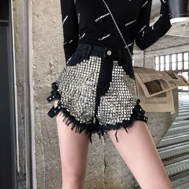 Fashionable black denim shorts with large silver stud embellishments and distressed edges