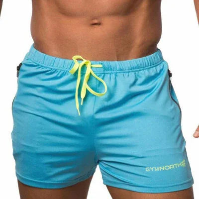 Close-up of a man's torso wearing light blue athletic shorts with neon yellow drawstring and Gymnorth logo