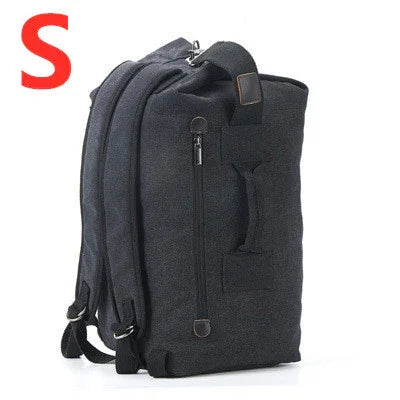 Small black canvas backpack with front zipper pocket and padded straps