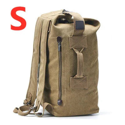 Small khaki canvas backpack with front zipper pocket and padded straps on white background